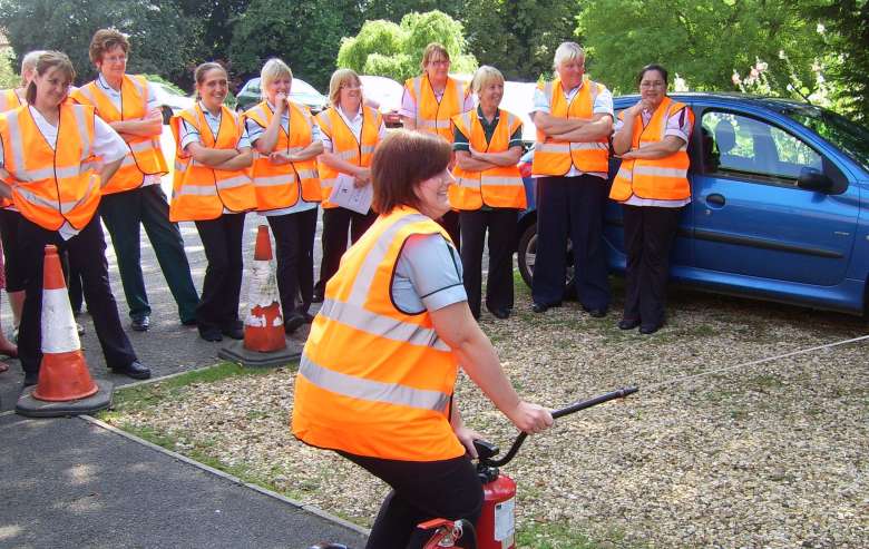 Staff training to use fire extinguishers during a fire safety awareness course