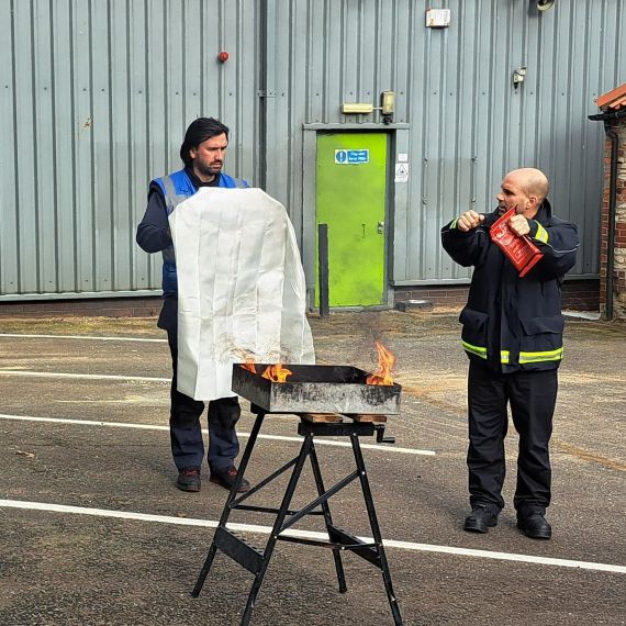 Paul instructing on how to correctly use a fire blanket
